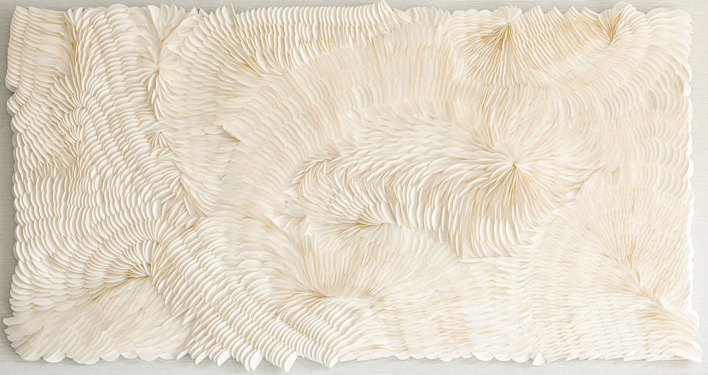 An unframed abstract origami wall art piece with a flowing disposition, white in color. Original artwork by Artist Tam M Olson