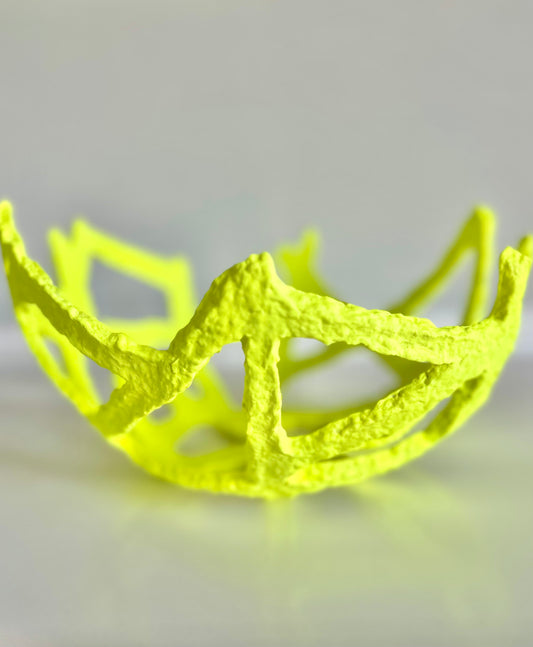 A neon yellow, geometric-patterned paper mache decorative bowl on a white background. Handmade by artist Tam M Olson.