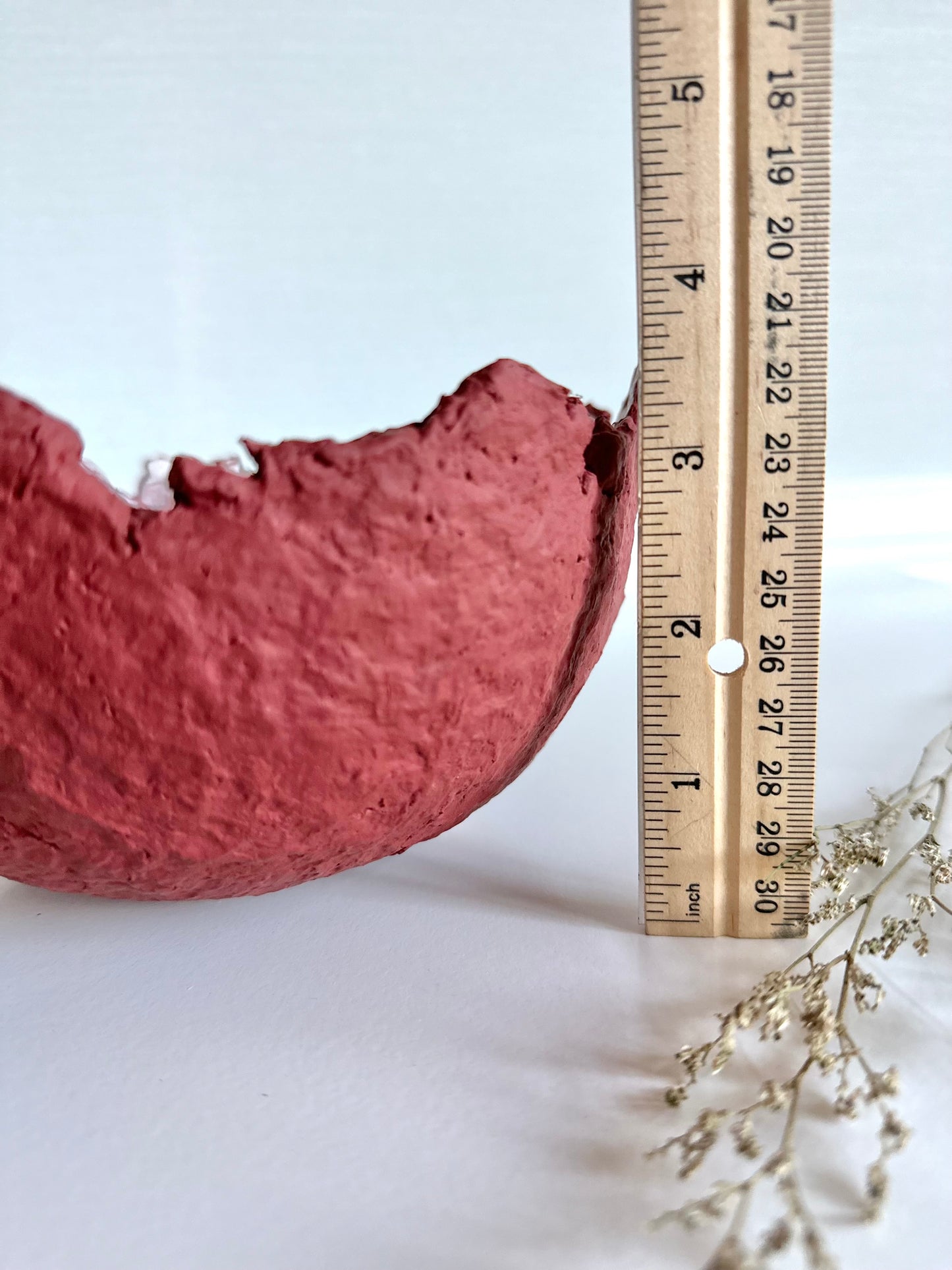 Close up view of a maroon eggshell decorative bowl with a rough torn edge, displaying height of 3.5 inches. Handcrafted by artist Tam M Olson.