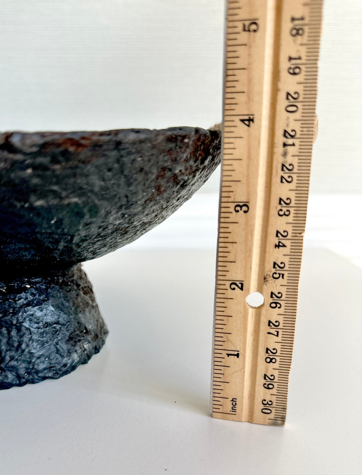 Close up of a black pedestal bowl made of paper mache, featuring a rustic and textured design, displaying a height of about 4 inches. Handcrafted by Artist Tam M Olson.