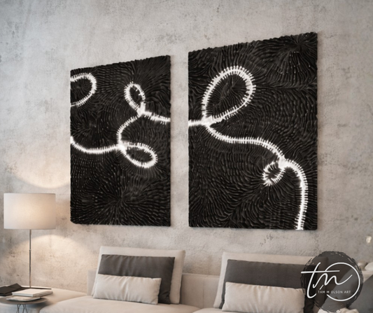 Two abstract dimensional and textured wall art pieces on a concrete wall above a bed. Original Art by Tam M Olson