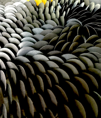 Close-up of a textured surface with wavy patterns in black and gold. Surface part of original abstract wall art by artist Tam M Olson.