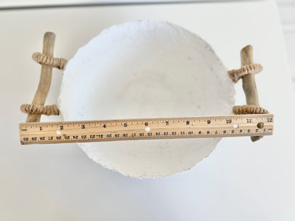 top down view of a handmade white paper mache bowl with driftwood and jute handles displaying total width of 12 inches. Designed by Artist Tam M Olson.