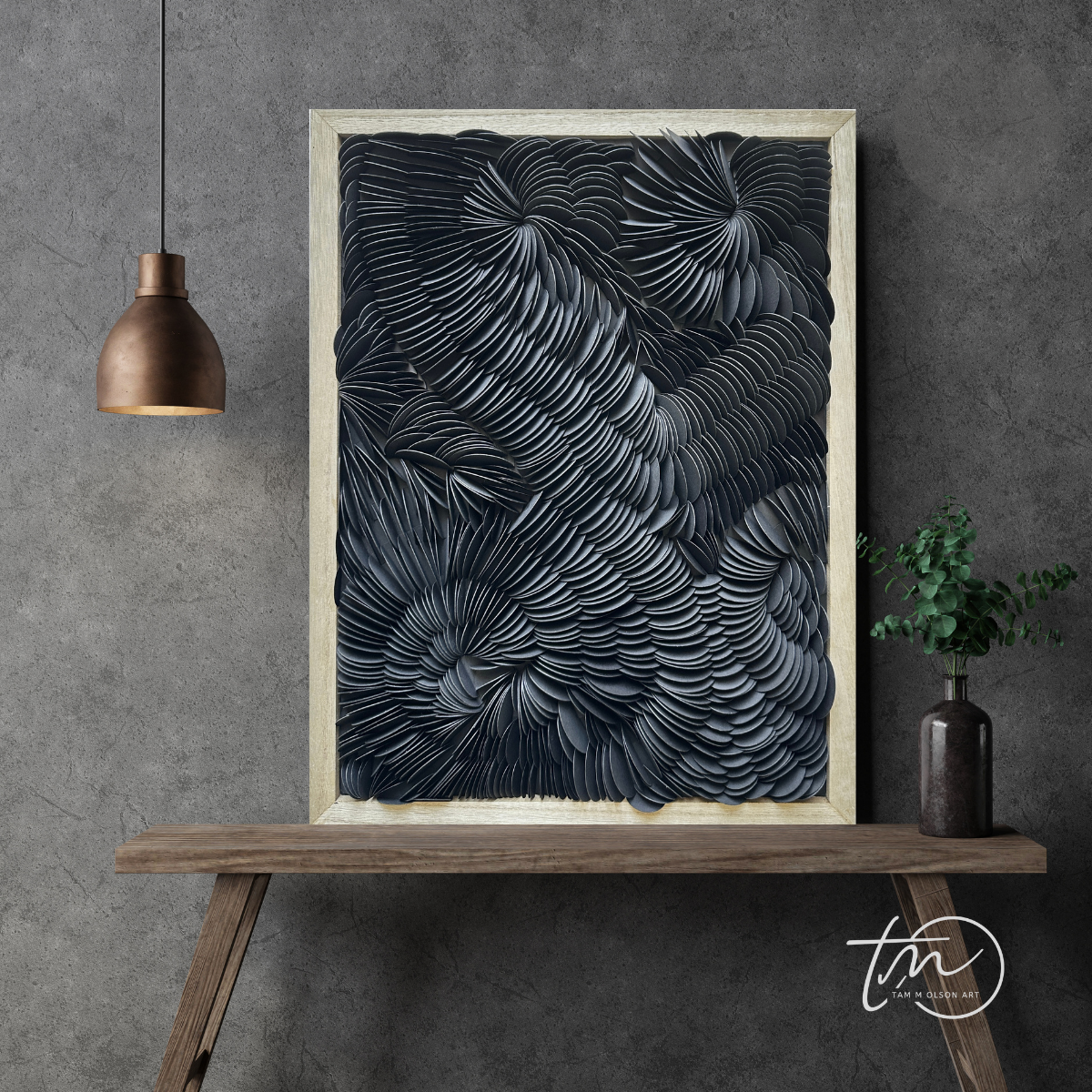 Framed abstract art piece on a wooden console table against a gray wall. Original black textured wall art by artist Tam M Olson.