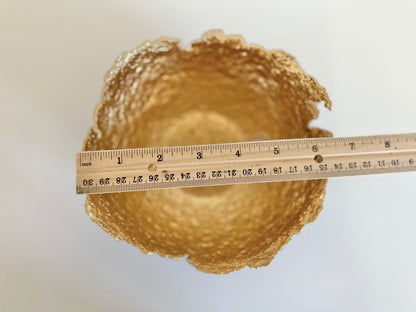 Interior of sculptural paper mache bowl. Textured and Gold in color measuring 6.5 inches wide. Original sculptural bowl by Artist Tam M Olson