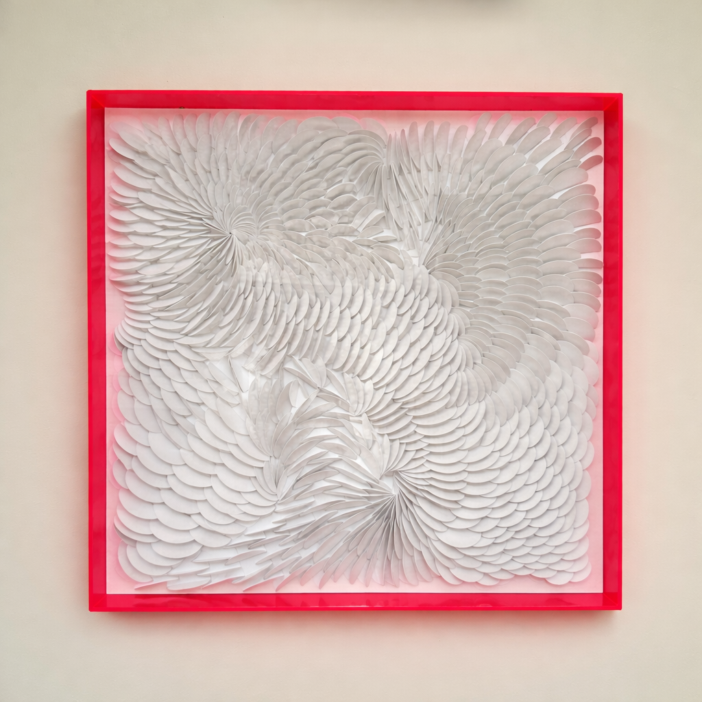 Abstract white artwork in an acrylic shadow box with a hot pink frame on a beige wall. Unique art by artist Tam M Olson