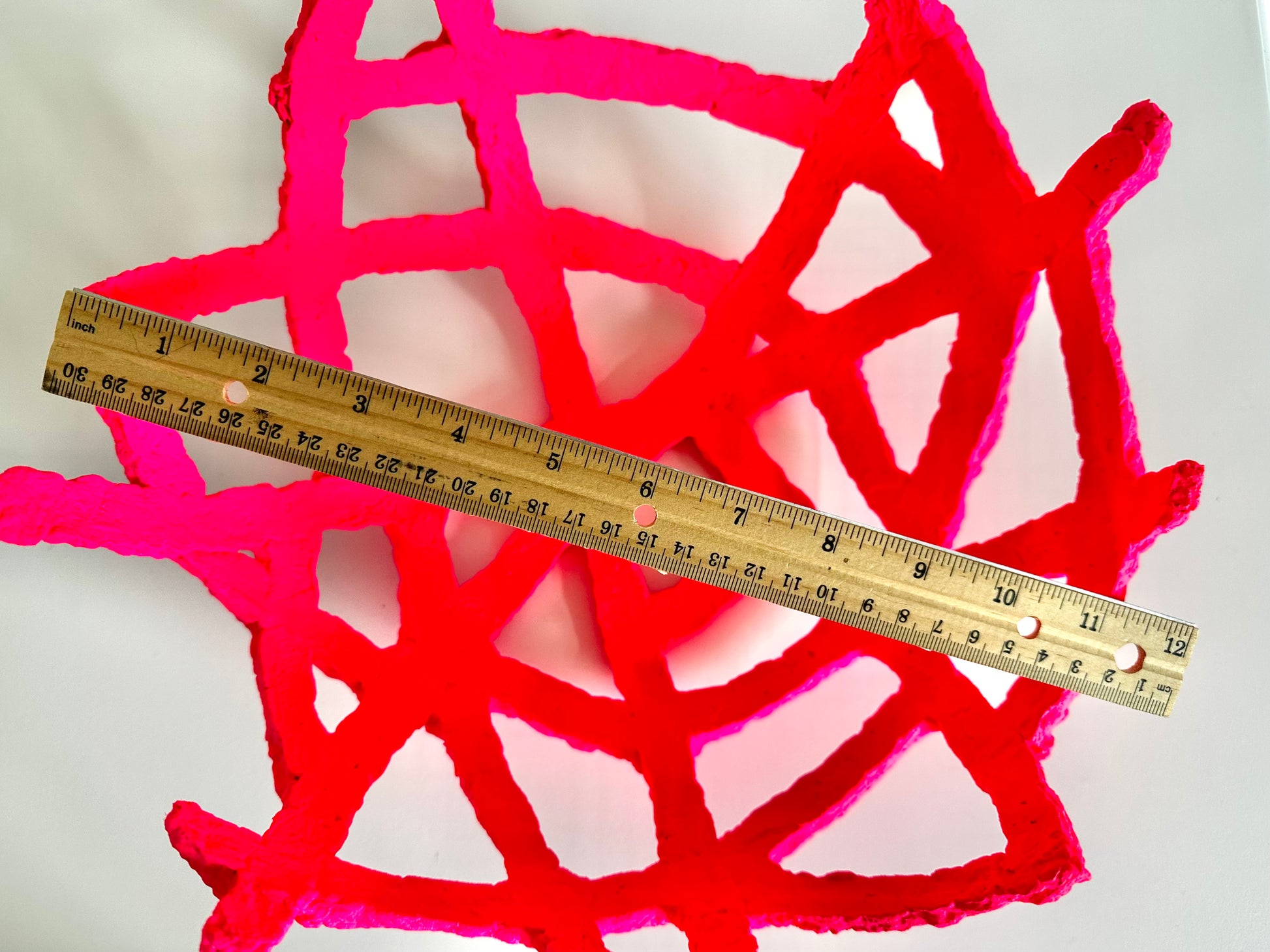 A hot pink, geometric-patterned paper mache decorative bowl on a white background. Measures about 12 inches wide. Handmade by artist Tam M Olson.