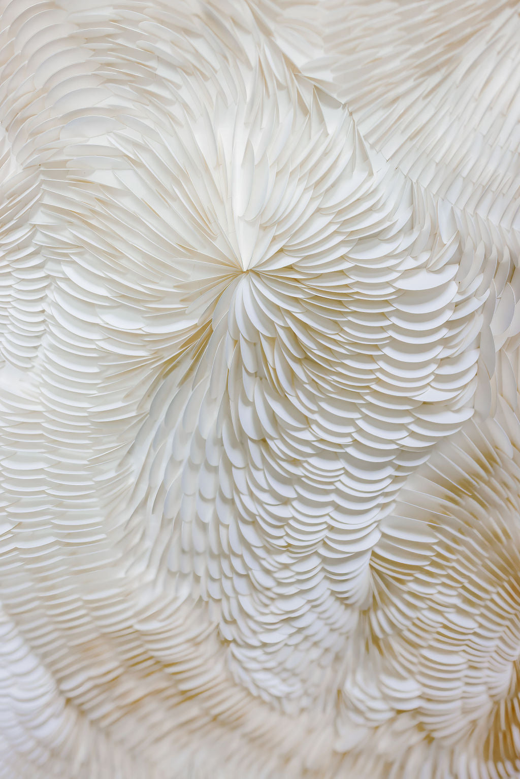 Close-up of a textured white art with concentric circular patterns. Original art by Tam M Olson