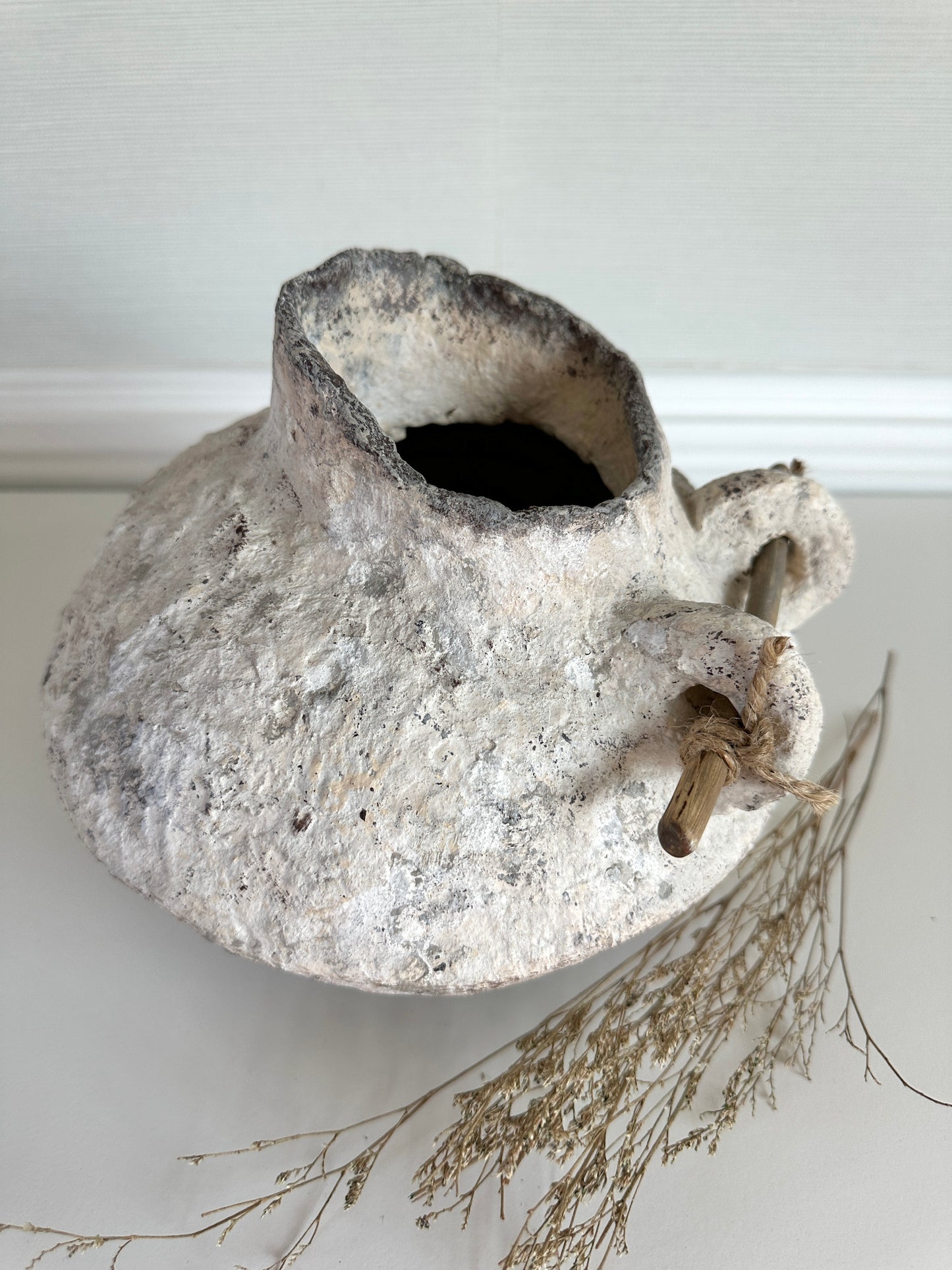 Vintage-style papier mache vase with a wooden handle detail on a white background. Handmade pitcher by artist Tam M Olson