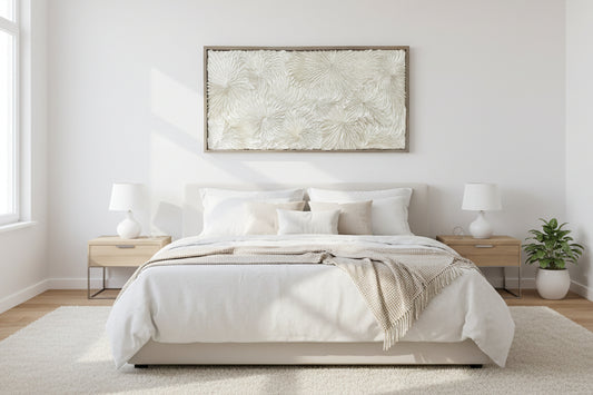 A framed dimensional abstract origami wall art displayed above a bed in a room with neutral color scheme. Commercial wall art by artist Tam M Olson.
