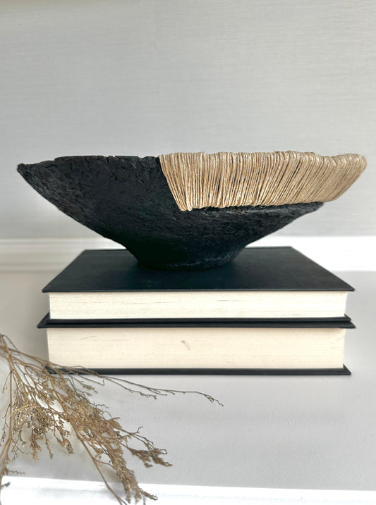 Decorative Black Bowl with Jute Twine and Wide Disposition on top of a small stack of books. Hand Made Paper Mache Bowl by Artist Tam M Olson.