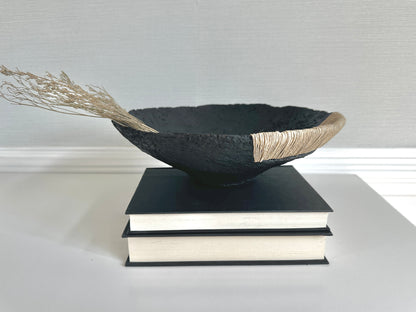 Decorative Black Bowl with Jute Twine and Wide Disposition on top of a small stack of books. Hand Made Paper Mache Bowl by Artist Tam M Olson.