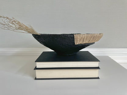 Decorative Black Bowl with Jute Twine and Wide Disposition on top of a small stack of books. Hand Made Paper Mache Bowl by Artist Tam M Olson.
