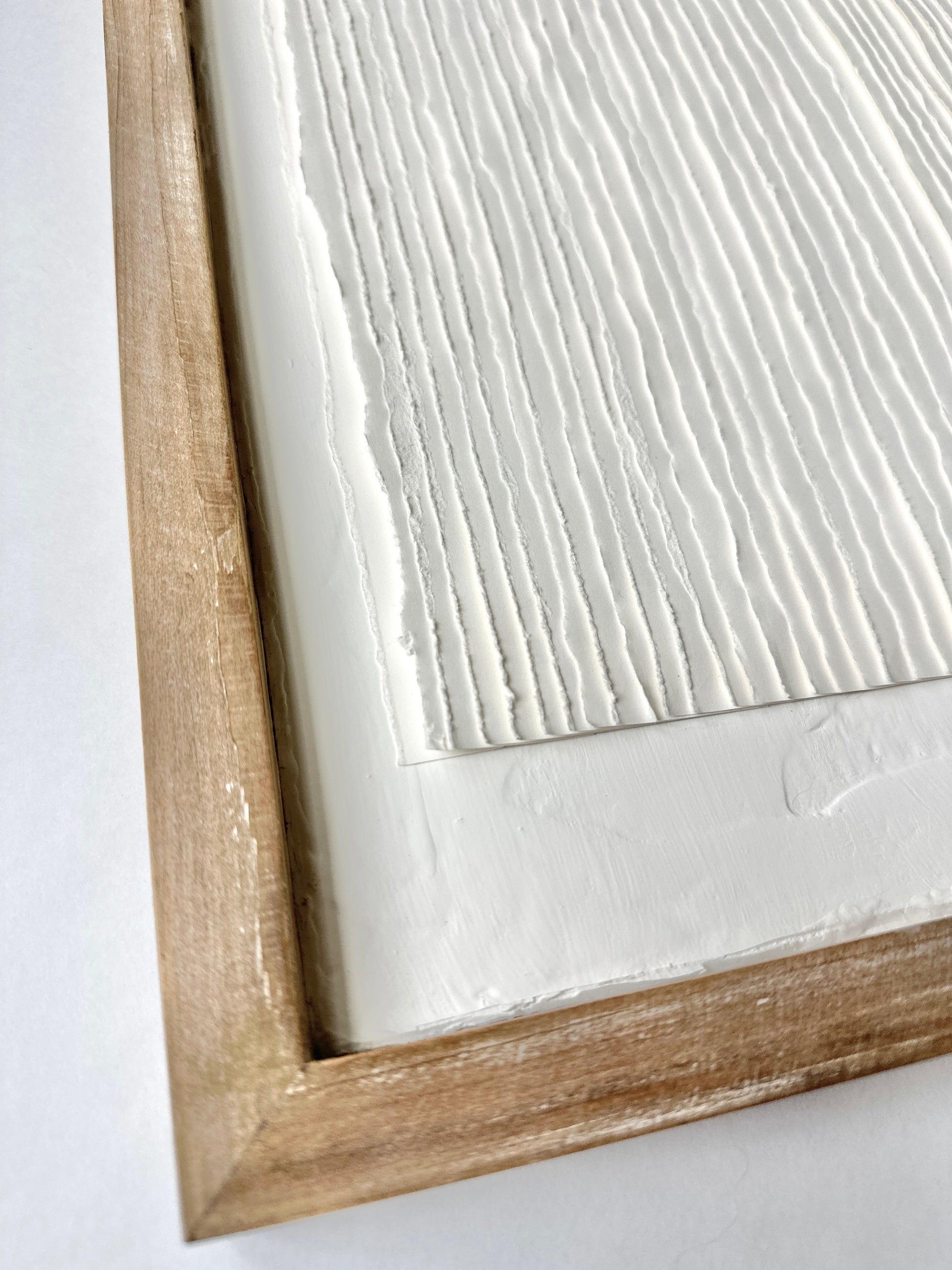 corner of pages art showcases textured background, wooden frame and rough torn edges of paper. Original artwork by Tam M Olson